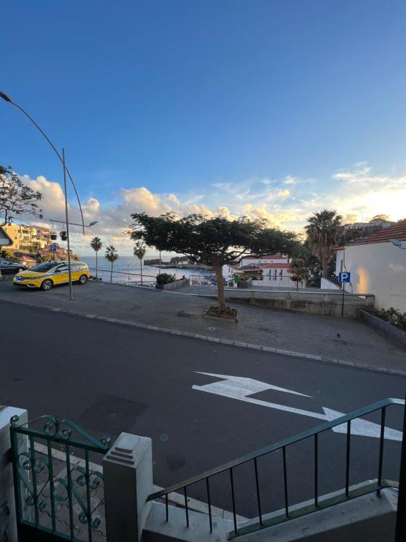 a street with a tree on the side of a road at Anchor House in Câmara de Lobos