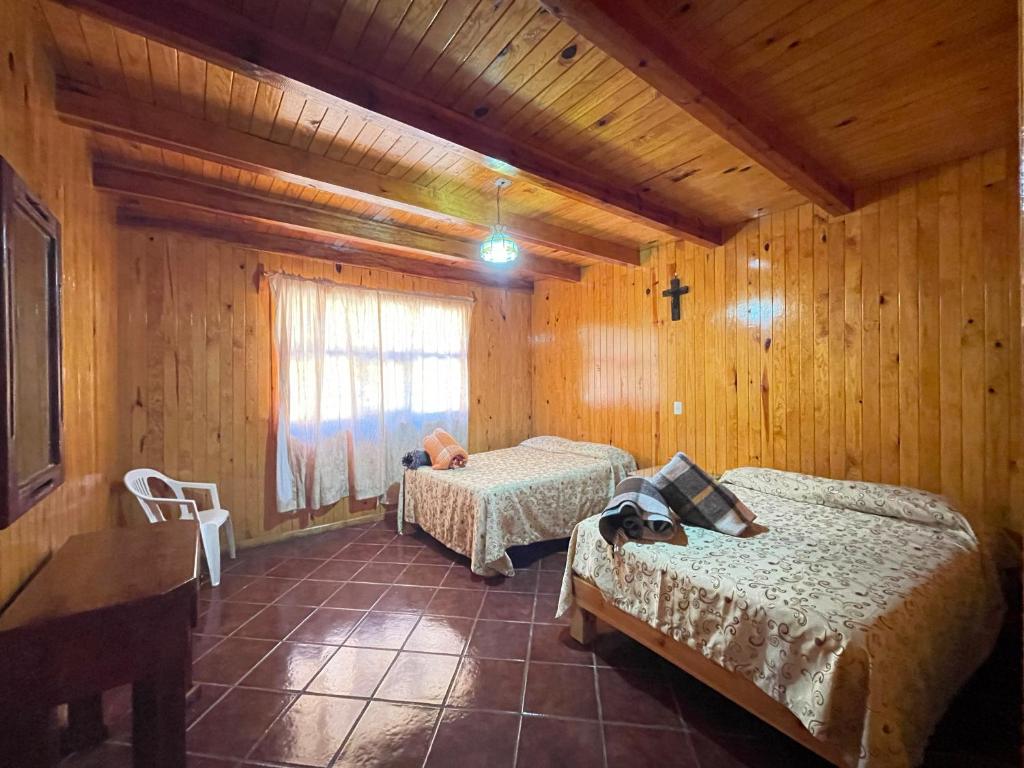 Postel nebo postele na pokoji v ubytování Cabañas Lupita