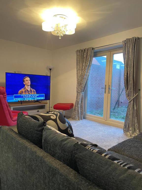 a living room with a couch and a tv at Boothferry Park Lodge in Hull