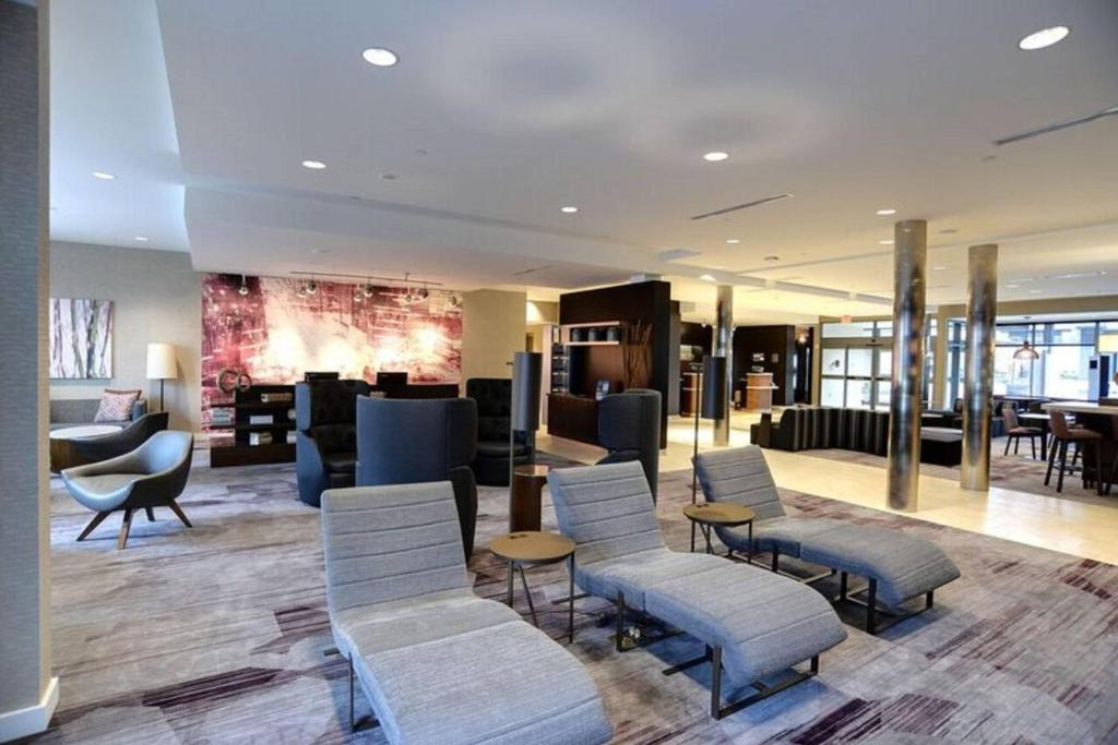 a lobby with chairs and tables and a waiting room at Courtyard by Marriott Columbus OSU in Columbus