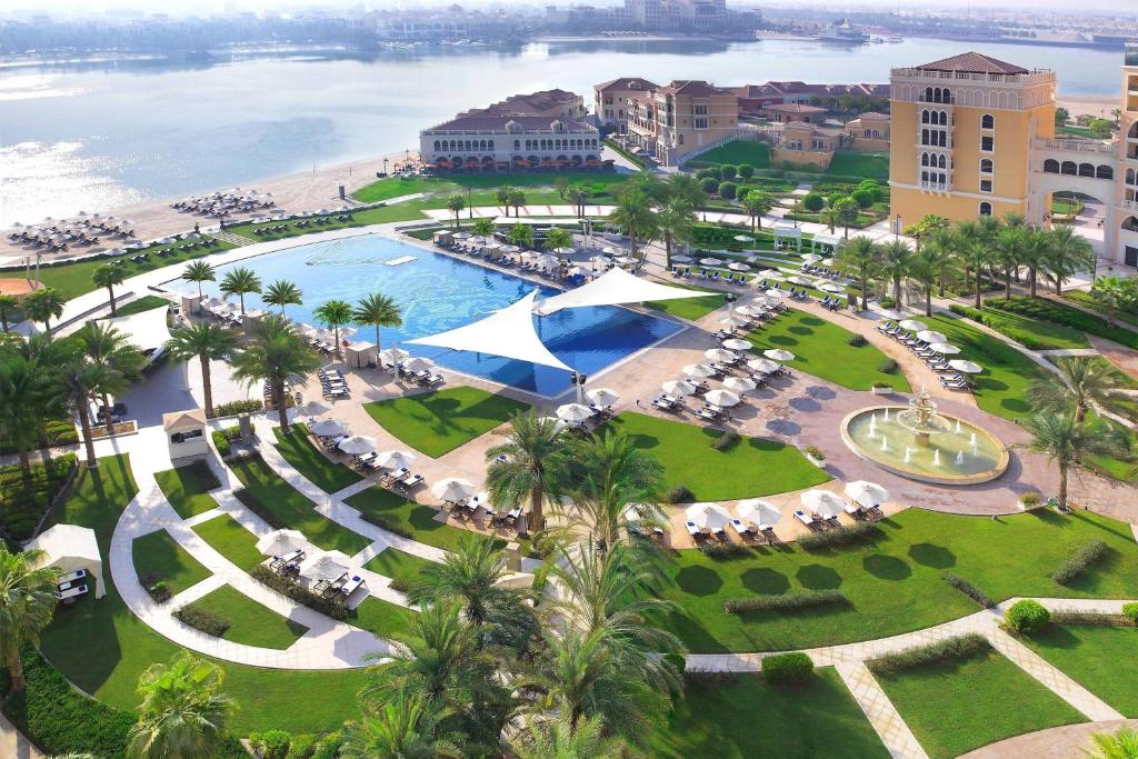 an aerial view of a resort with a pool and a beach at The Ritz-Carlton Abu Dhabi, Grand Canal in Abu Dhabi