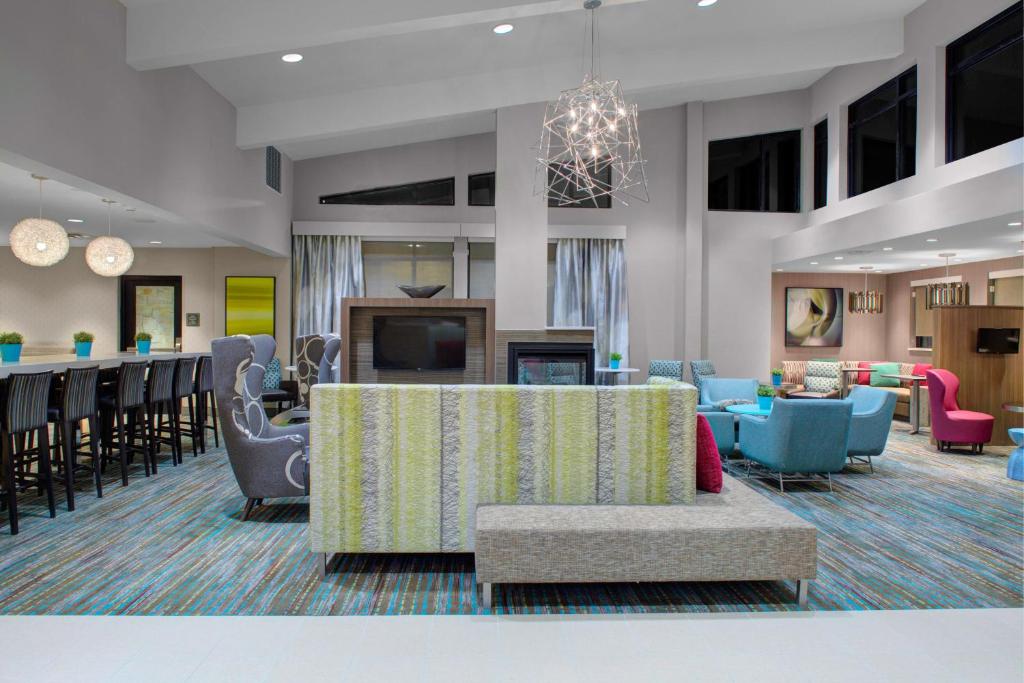 a lobby with a waiting area with chairs and tables at Residence Inn by Marriott Dallas Allen/Fairview in Fairview
