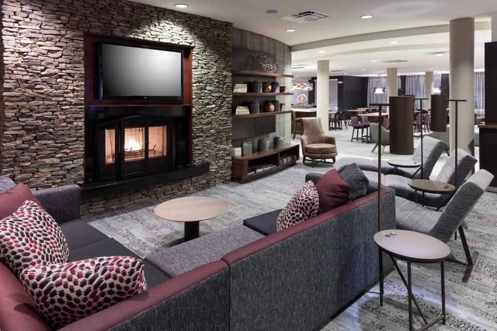 a lobby with a couch and a fireplace at Courtyard by Marriott Birmingham Trussville in Trussville