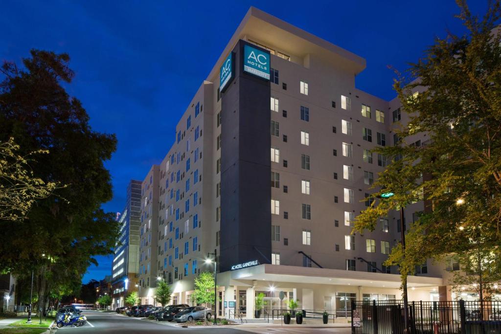 an image of a hotel at night at AC Hotel by Marriott Gainesville Downtown in Gainesville
