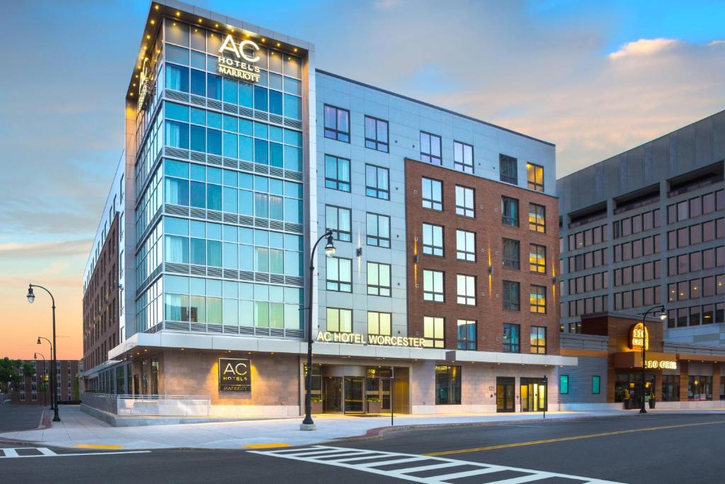 a large building with a sign on it on a street at AC Hotel by Marriott Worcester in Worcester