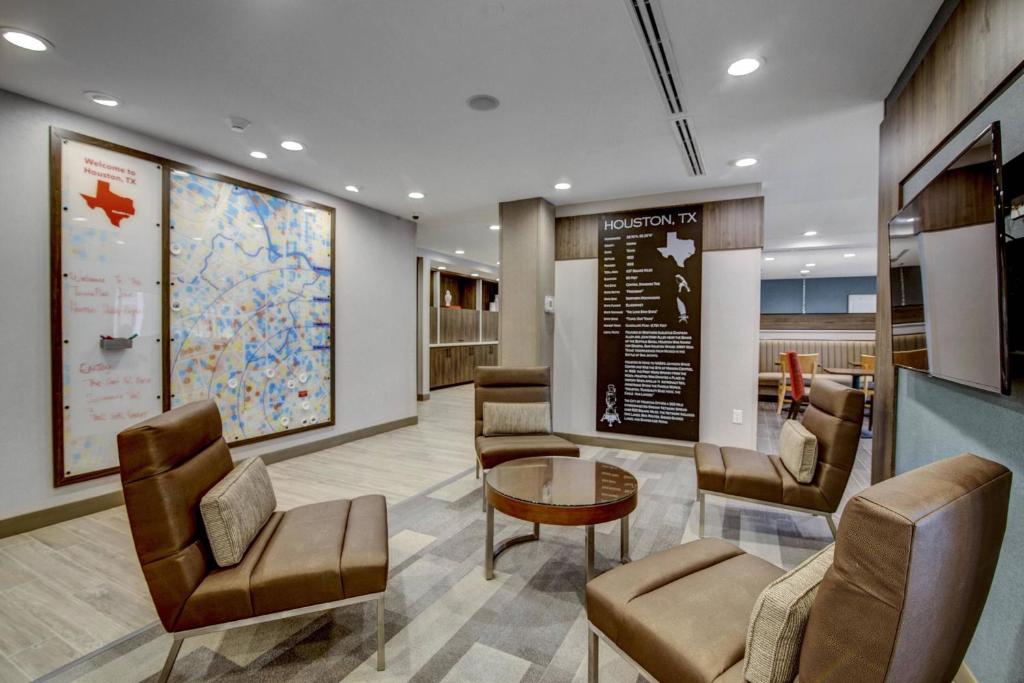 a waiting area in a hospital with chairs and a table at TownePlace Suites by Marriott Houston Hobby Airport in Houston