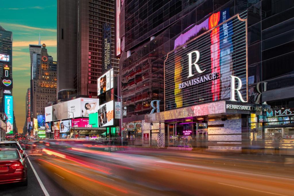a busy city street with buildings and cars at night at Renaissance New York Times Square Hotel in New York