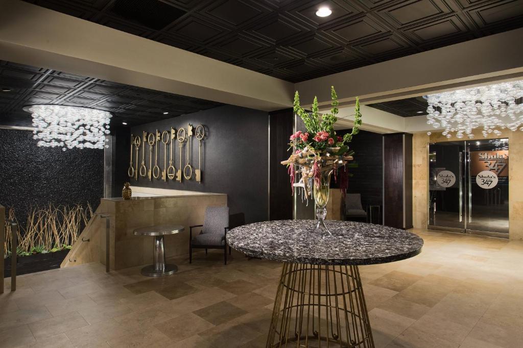 a lobby with a table with flowers on it at Hotel Duval, Autograph Collection in Tallahassee