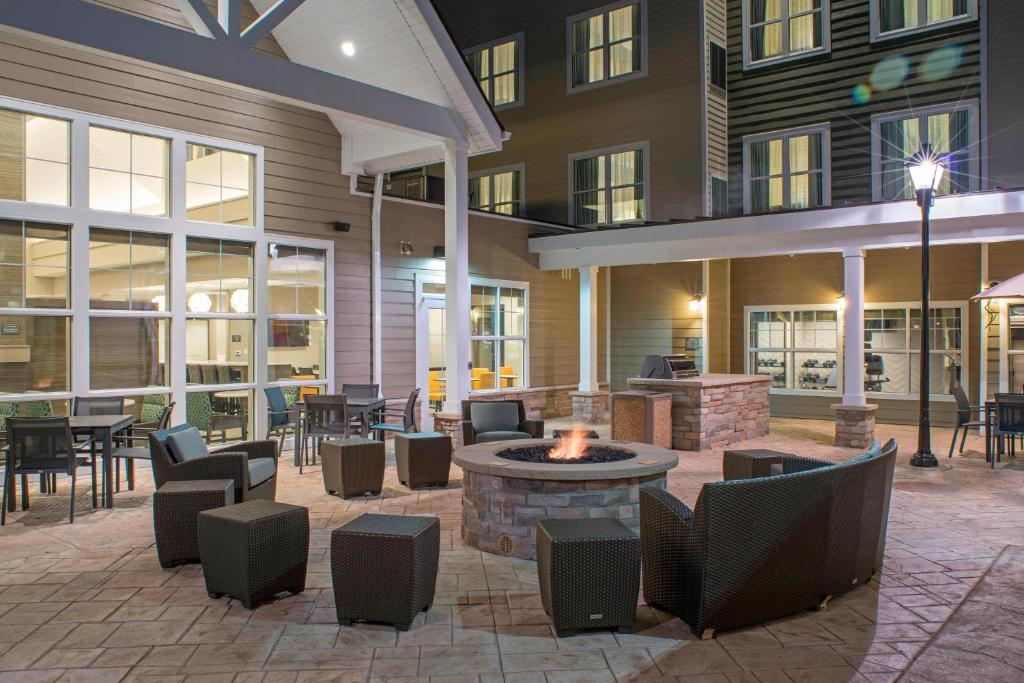 an outdoor patio with a fire pit and tables and chairs at Residence Inn by Marriott Albany Clifton Park in Clifton Park