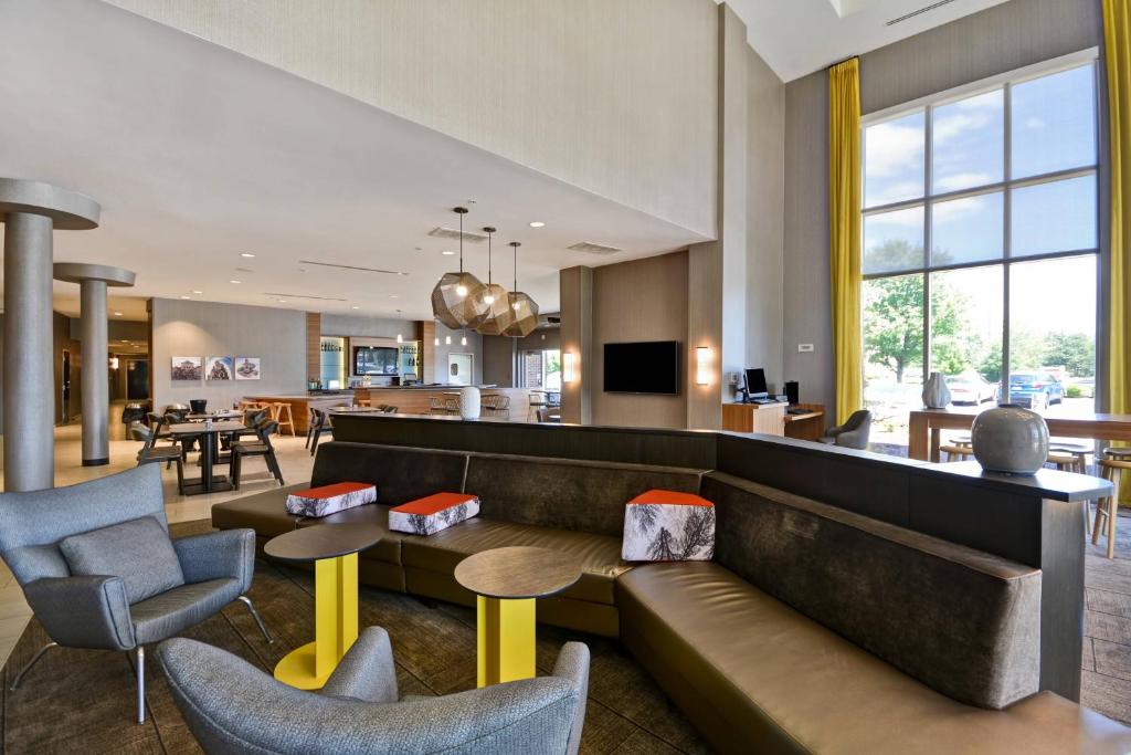 a hotel lobby with a couch and chairs at SpringHill Suites by Marriott Indianapolis Airport/Plainfield in Plainfield