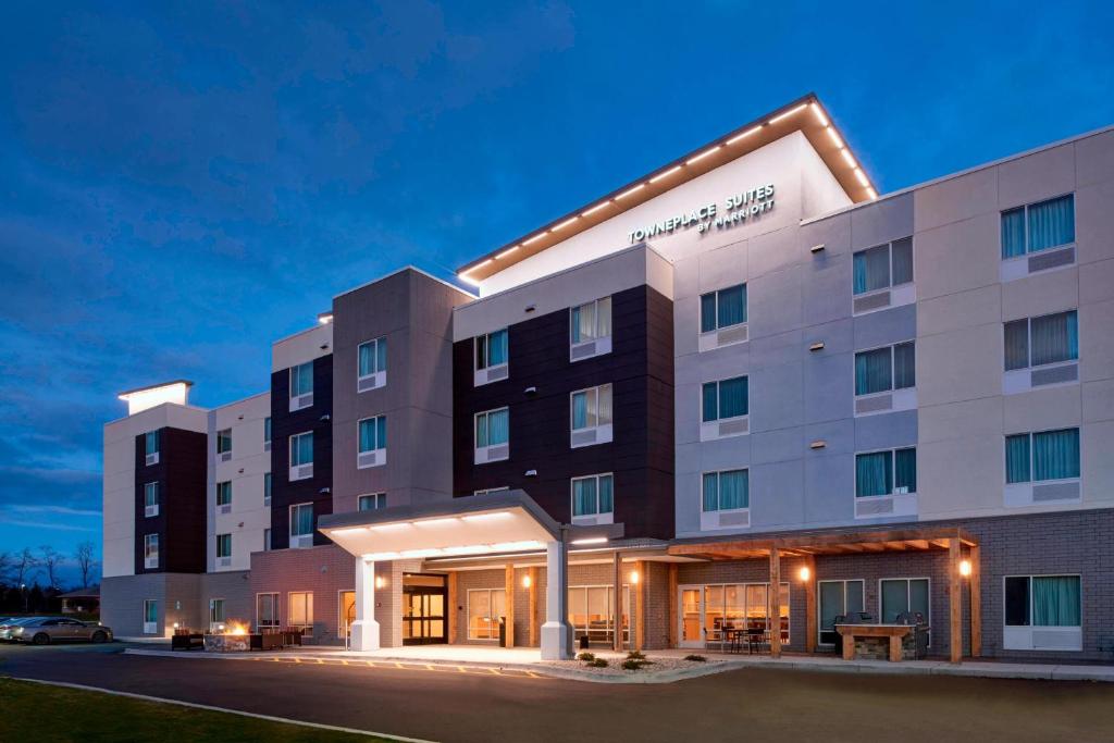 a rendering of the front of a hotel at night at TownePlace Suites by Marriott Grand Rapids Airport in Grand Rapids