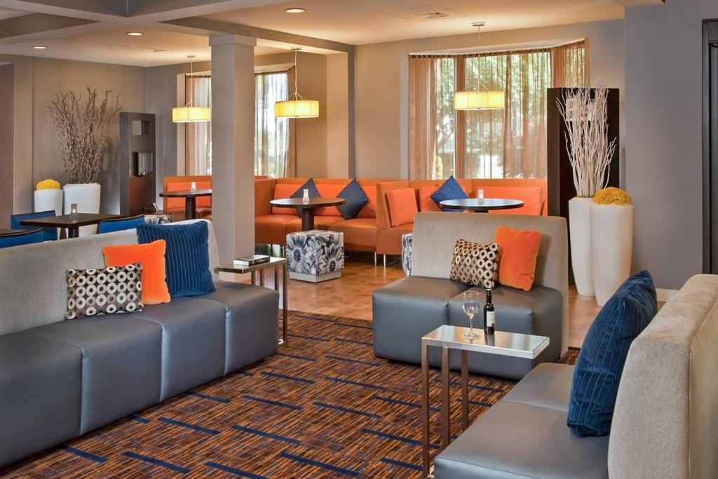 a living room with couches and tables at Courtyard by Marriott Frederick in Frederick