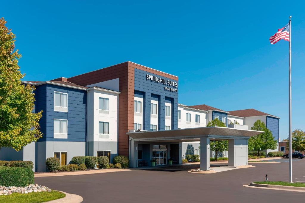 a rendering of a hotel building with an american flag at SpringHill Suites Grand Rapids North in Grand Rapids