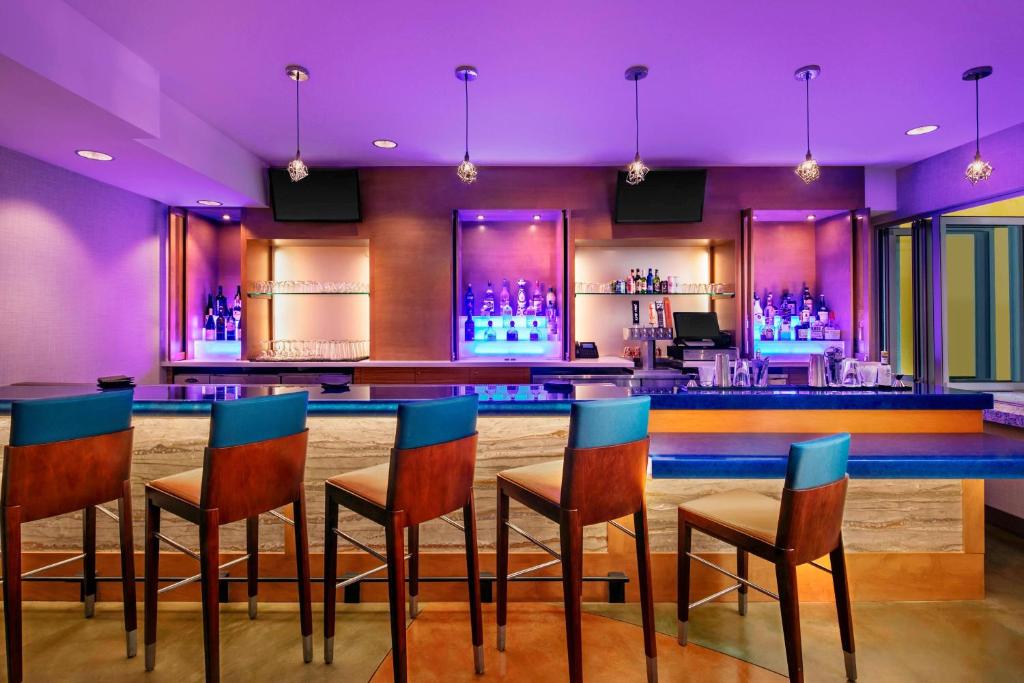 a bar with chairs and a bar counter with purple lighting at TownePlace Suites by Marriott San Diego Downtown in San Diego