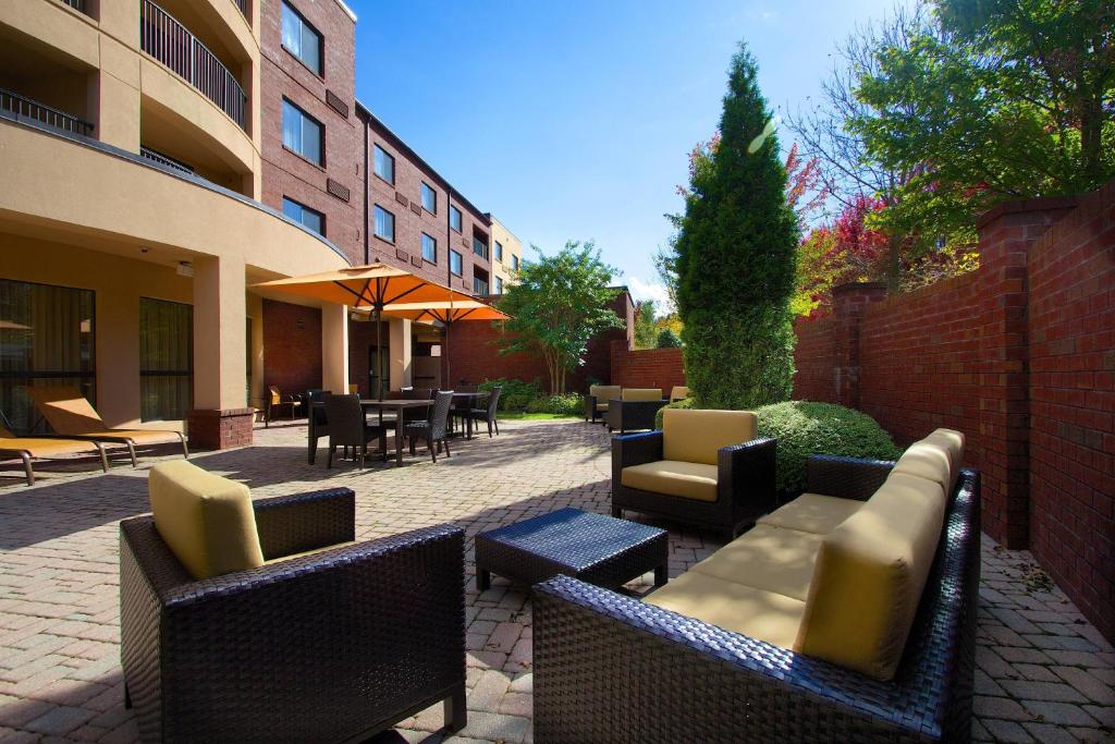 a patio with chairs and tables and a building at Courtyard Blacksburg in Blacksburg