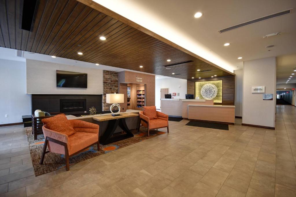 a lobby with chairs and a table and a living room at Fairfield Inn & Suites by Marriott Milwaukee North in Glendale