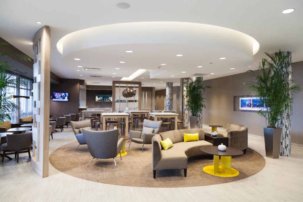 a lobby of a hotel with chairs and tables at SpringHill Suites by Marriott Somerset Franklin Township in Somerset