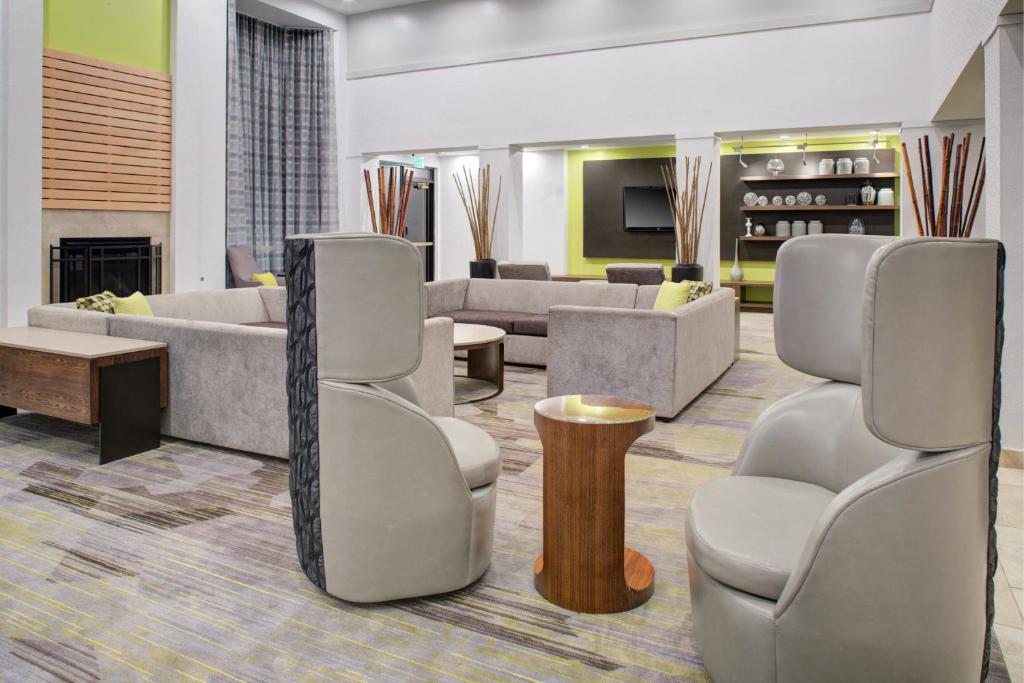 a lobby with couches and chairs and a fireplace at Courtyard Richmond Chester in Chester