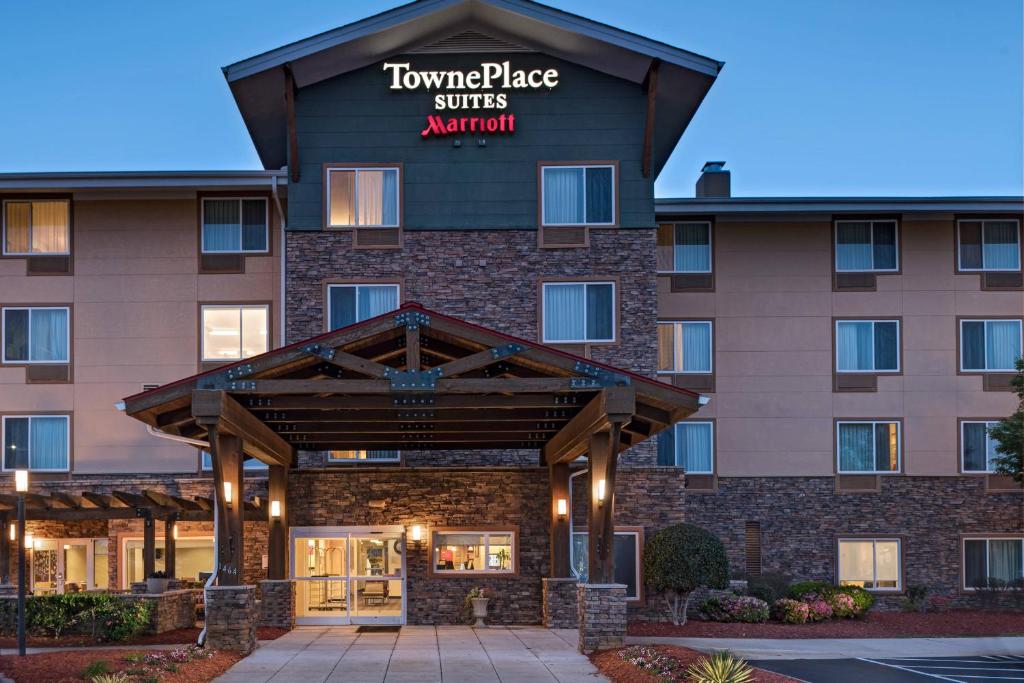 a front view of a hotel with a sign that reads tower place suites aquarium at TownePlace Suites Fayetteville Cross Creek in Fayetteville