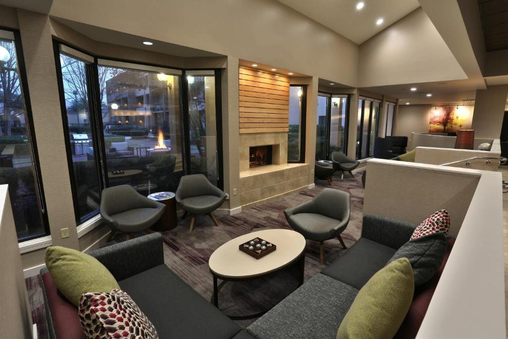 a lobby with a couch and chairs and a fireplace at Courtyard Montgomery in Montgomery