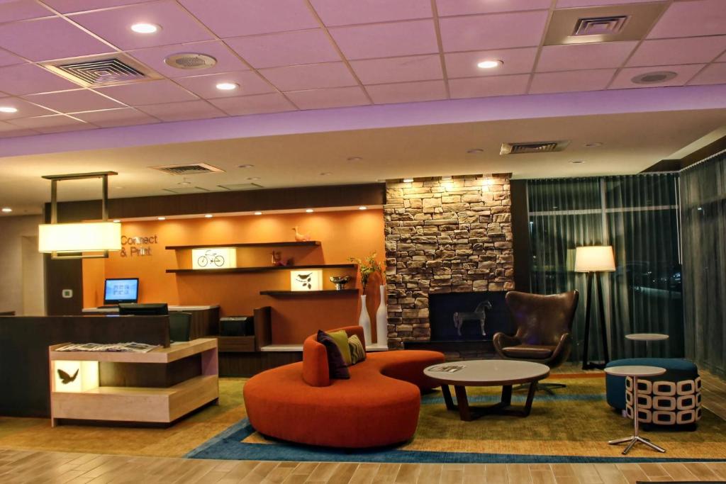 hol hotelu z krzesłem i stołem w obiekcie Fairfield Inn & Suites by Marriott Reading Wyomissing w mieście Wyomissing