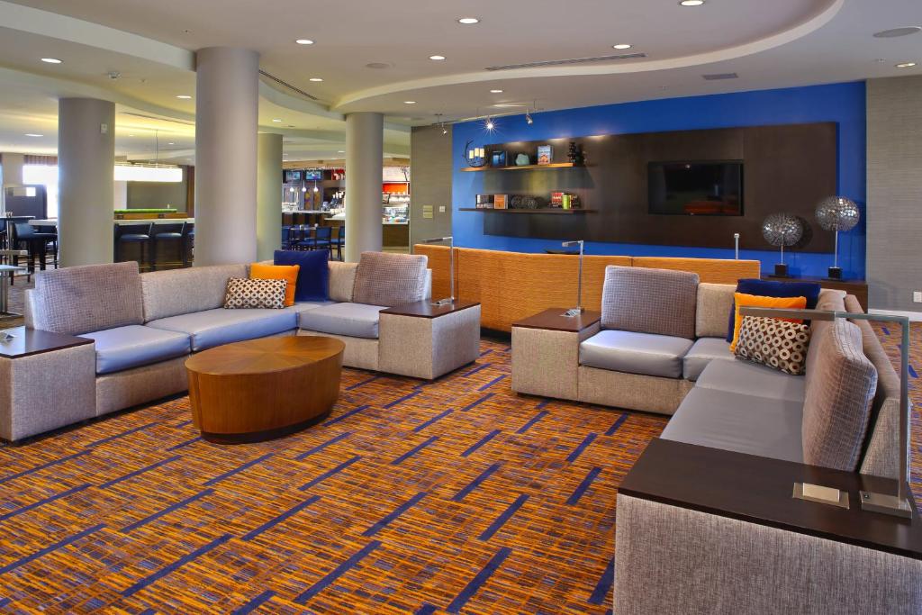 a lobby with couches and a bar in a hotel at Courtyard by Marriott Hamilton in Hamilton