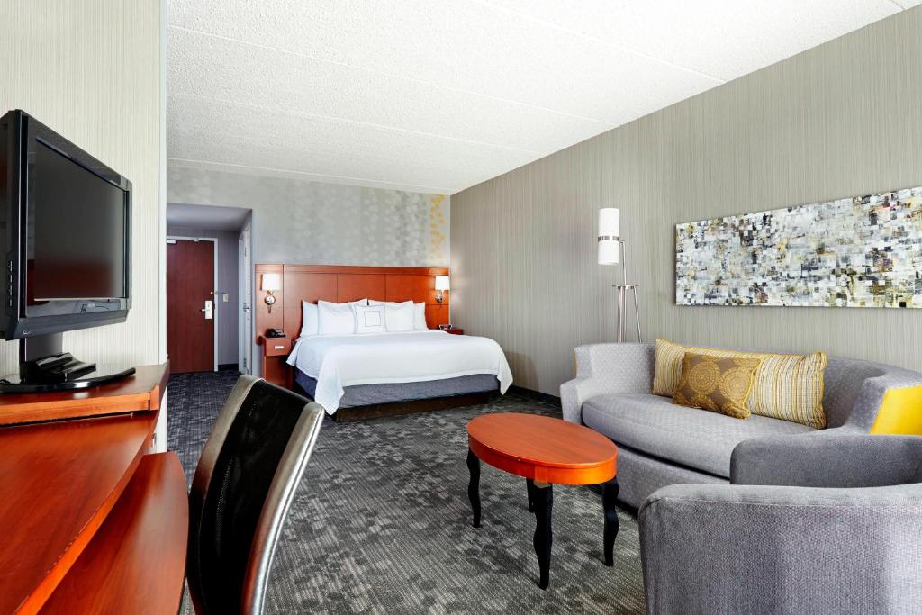 a hotel room with a bed and a television at Courtyard Phoenix North / Happy Valley in Phoenix