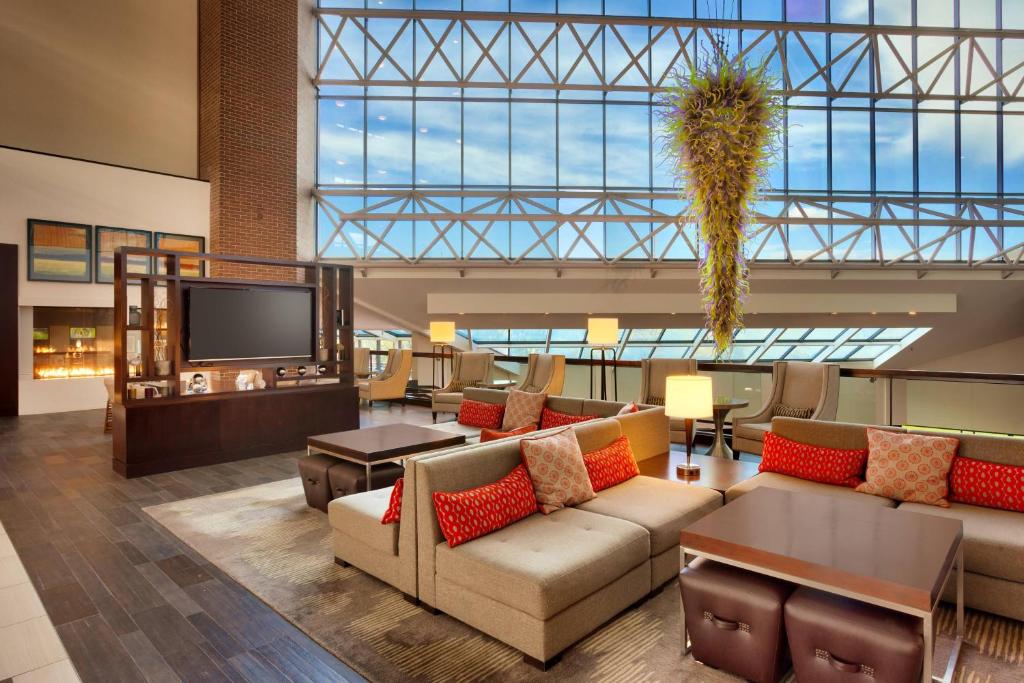 a lobby with couches and a flat screen tv at Salt Lake City Marriott University Park in Salt Lake City
