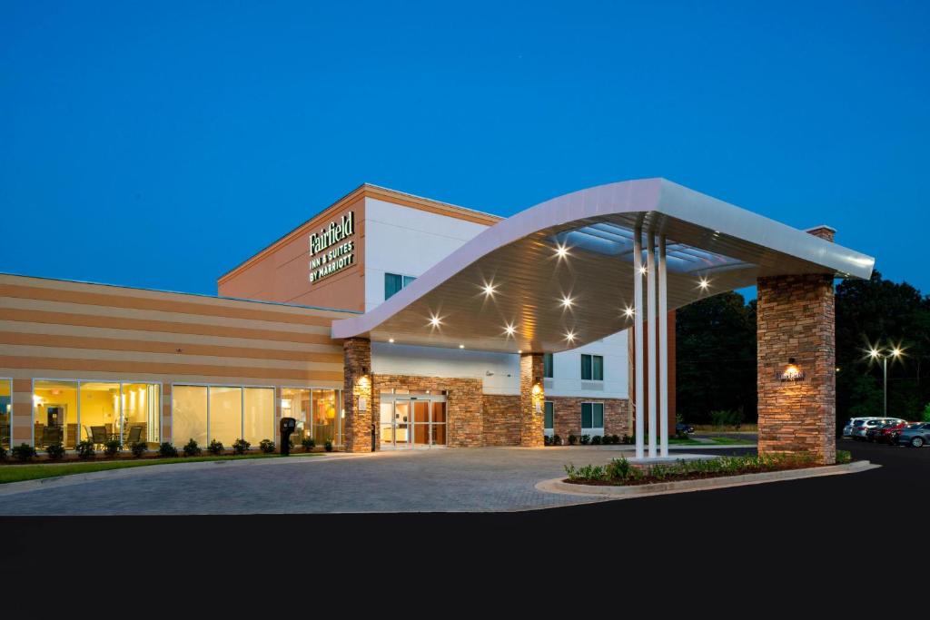 a hospital building with a lit up entrance at night at Fairfield Inn & Suites by Marriott Batesville in Batesville