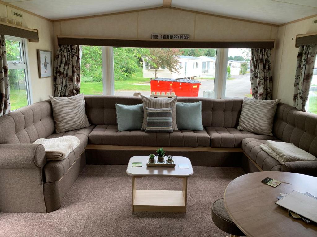 a living room with a couch and a table at Sunrise 132 in Lincolnshire