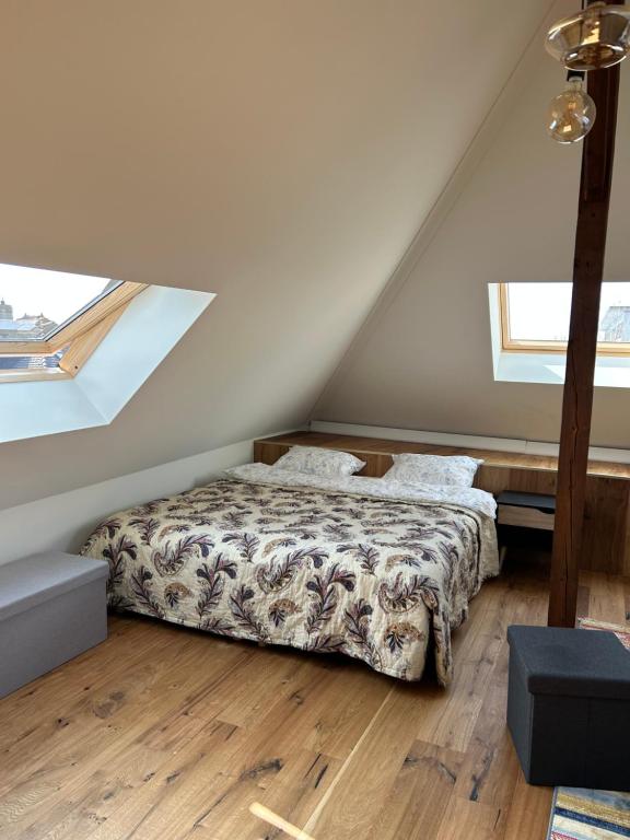a bedroom with a bed in a attic at Les Magniolas in Prilly
