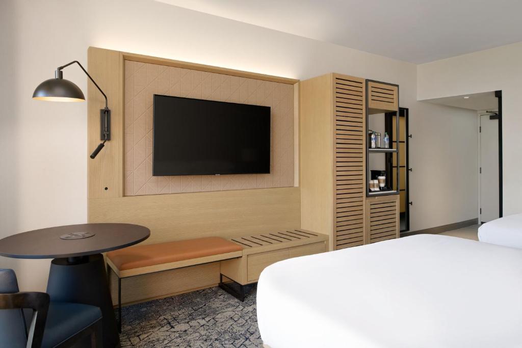 a hotel room with a bed and a flat screen tv at Sheraton Park Hotel at the Anaheim Resort in Anaheim
