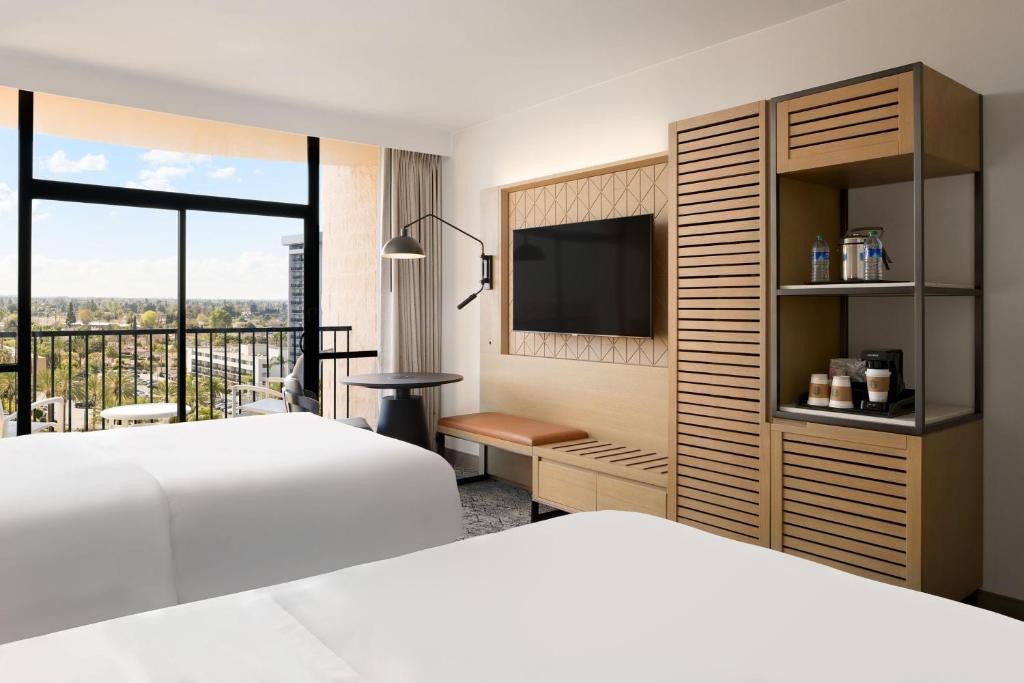 a hotel room with a bed and a television at Sheraton Park Hotel at the Anaheim Resort in Anaheim