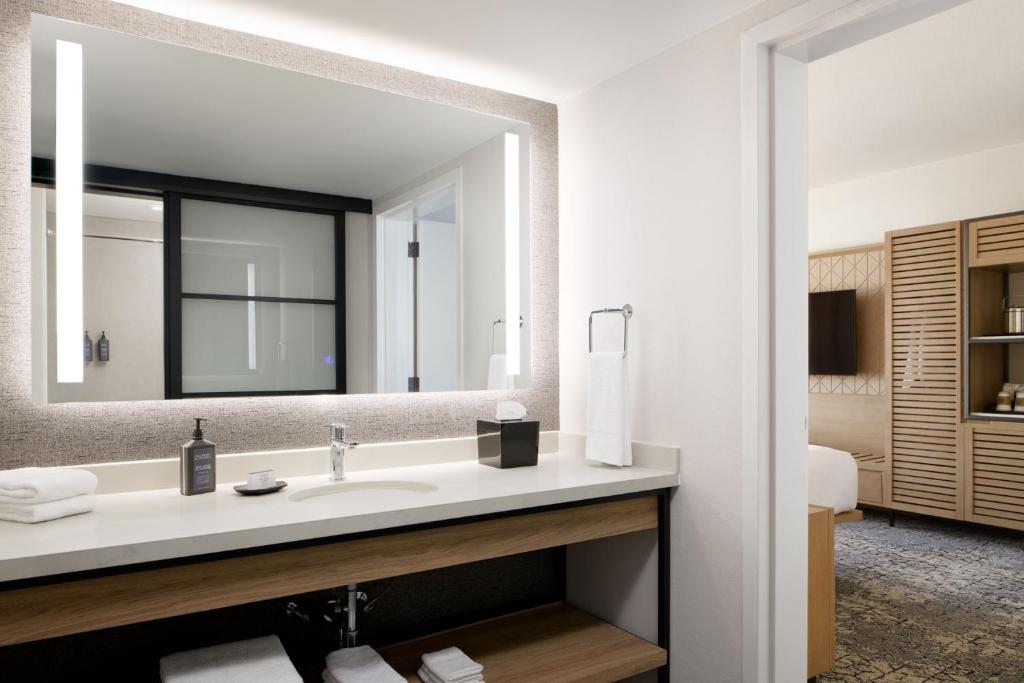 a bathroom with a sink and a mirror at Sheraton Park Hotel at the Anaheim Resort in Anaheim