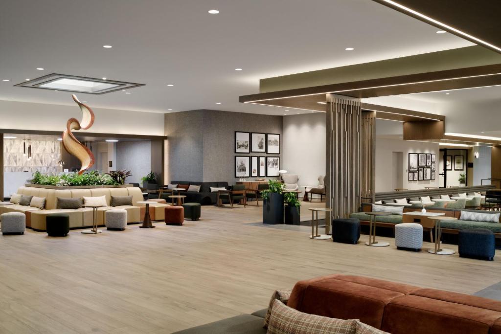 a lobby of a hotel with couches and tables at Sheraton Park Hotel at the Anaheim Resort in Anaheim