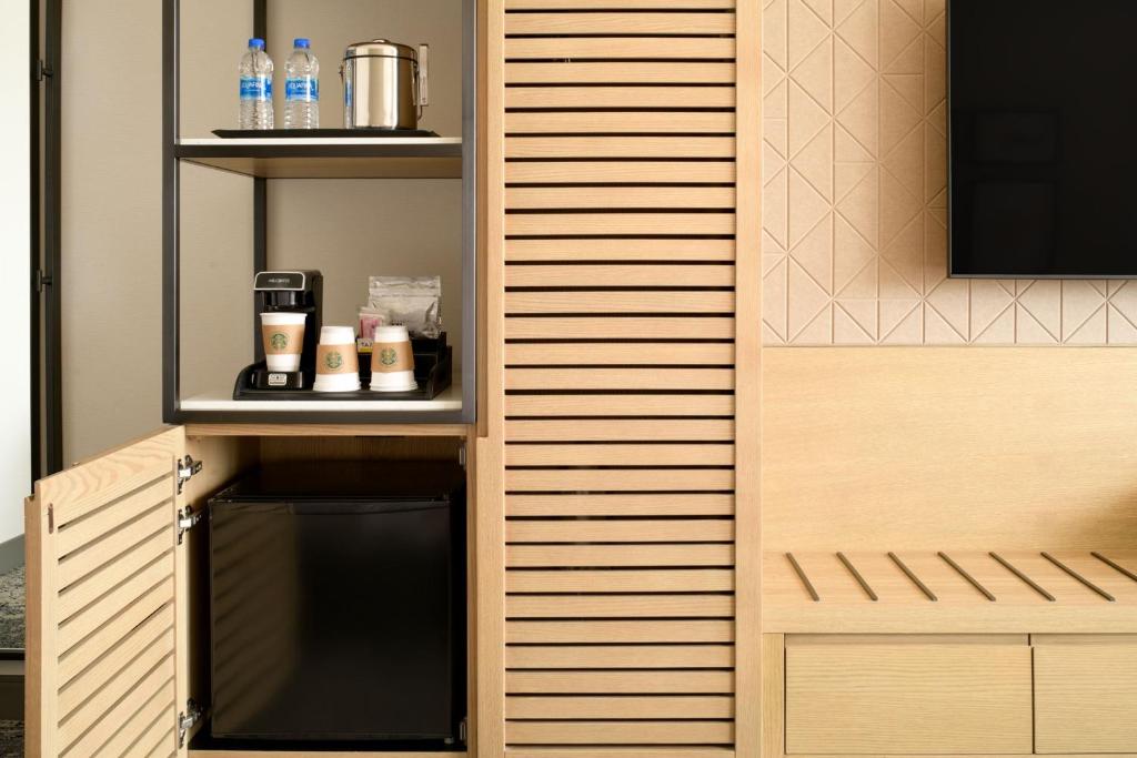 a room with a wooden wall with a black oven at Sheraton Park Hotel at the Anaheim Resort in Anaheim