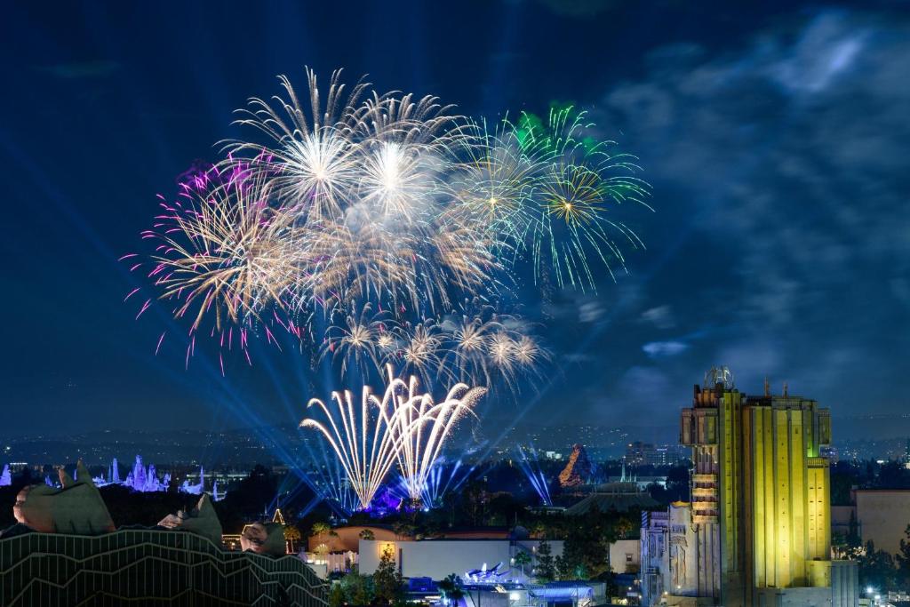 a fireworks display over a city at night at Sheraton Park Hotel at the Anaheim Resort in Anaheim