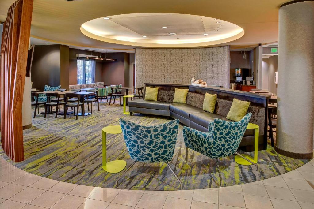 a lobby with a couch and chairs and tables at SpringHill Suites by Marriott Naples in Naples