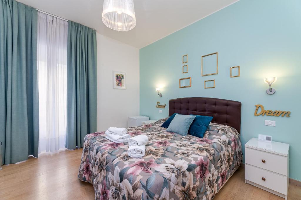 a bedroom with a large bed with blue walls at St. Peter's Relax in Rome