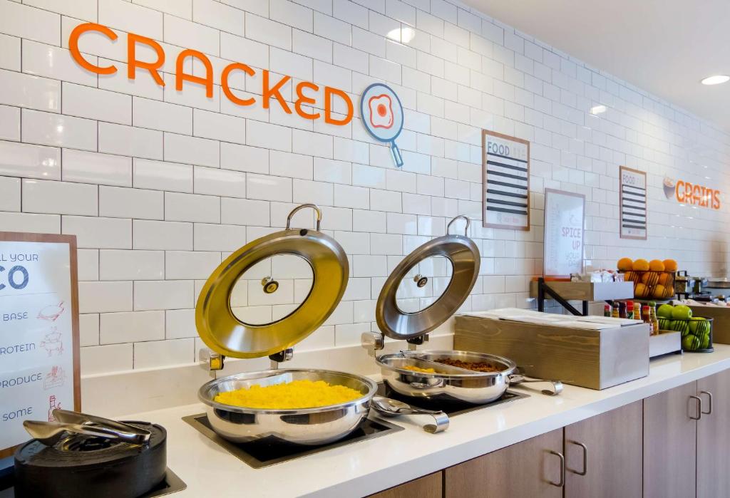 a kitchen with three pans of food on a counter at Sonesta ES Suites Flagstaff in Flagstaff