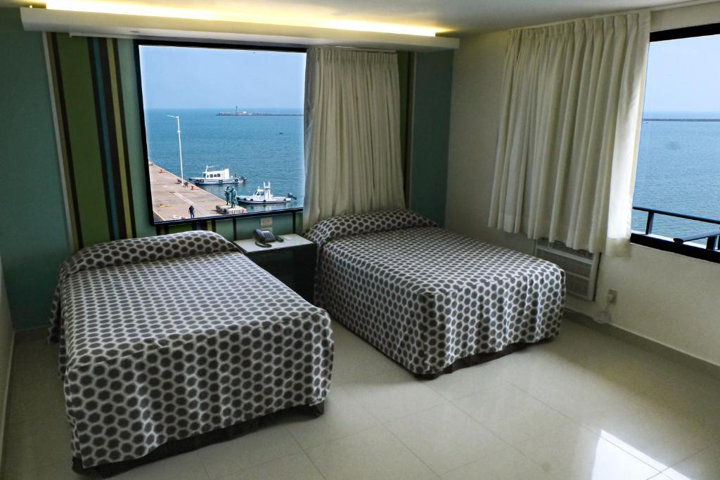 Postel nebo postele na pokoji v ubytování Hotel Mar y Tierra