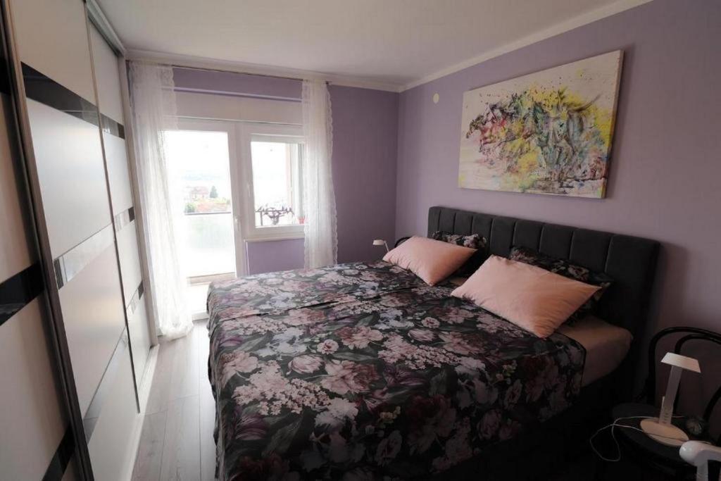 a bedroom with a bed and a window in it at Apartments with WiFi Sibenik - 20831 in Šibenik