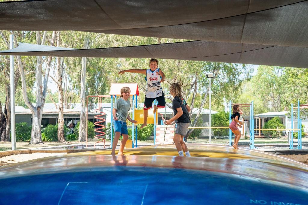 un gruppo di bambini intorno alla piscina di Ingenia Holidays Murray Bend a Koonoomoo
