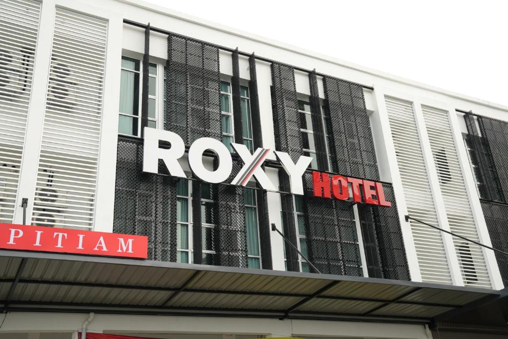 a ryley hotel sign on top of a building at Roxy Hotel Aiman in Kuching
