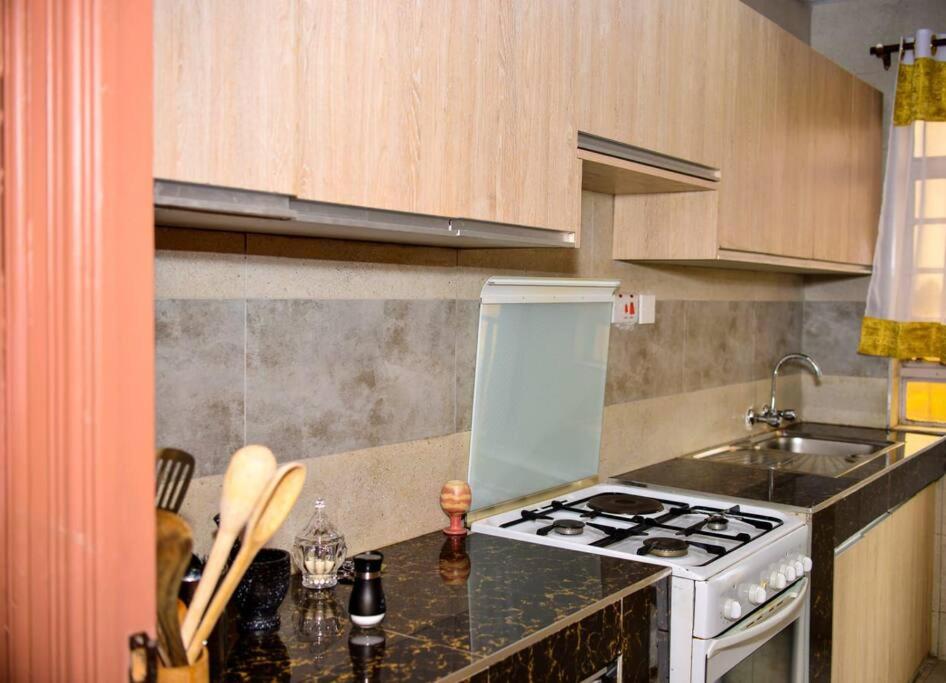 a kitchen with a stove and a counter top at Nova Homes in Thika