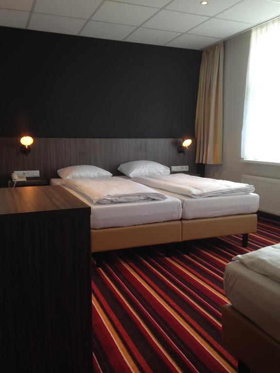 Postel nebo postele na pokoji v ubytování Mozart Hotel
