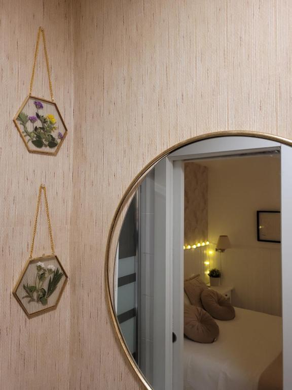 a mirror on a wall with a bed in a room at "COZY LOFT", TERRACE, PARKING and SWIMMING POOL in Málaga
