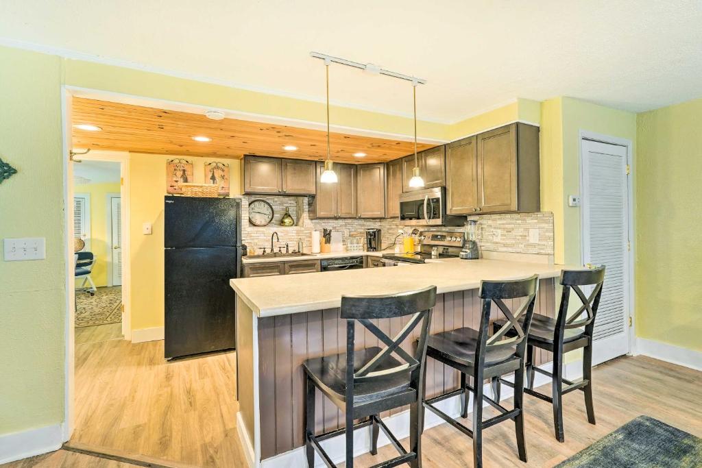 a kitchen with a island with bar stools at Johnson City Vacation Rental 1 Block to ETSU in Johnson City