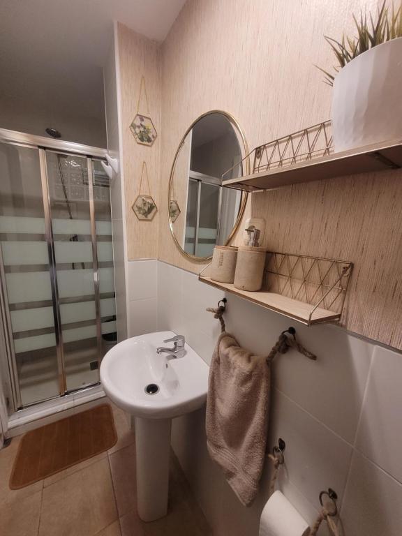 a bathroom with a sink and a mirror at "COZY LOFT", TERRACE, PARKING and SWIMMING POOL in Málaga