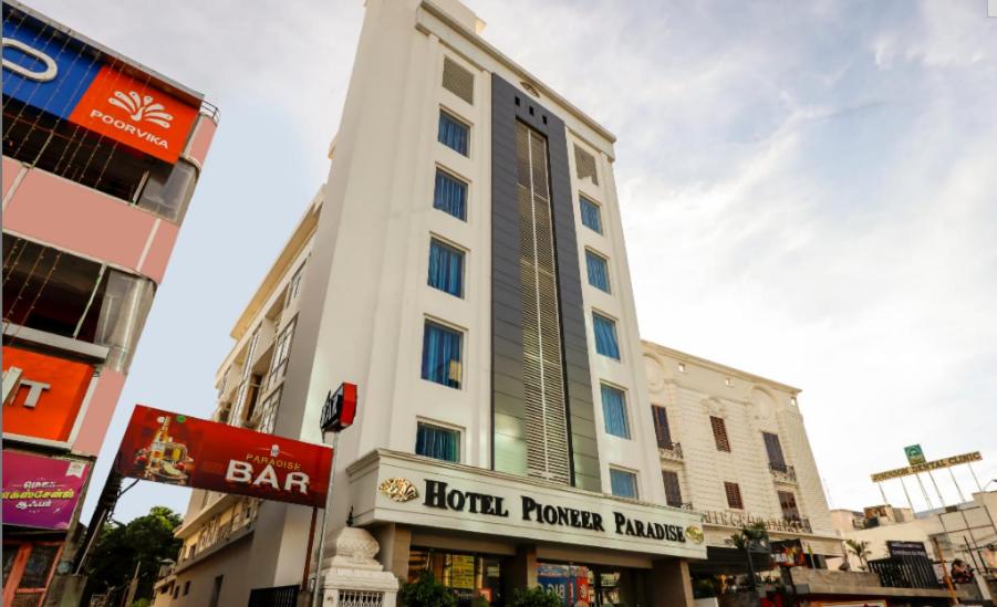 a tall white building with a hotel tower building at HOTEL PIONEER PARADISE in Nāgercoil